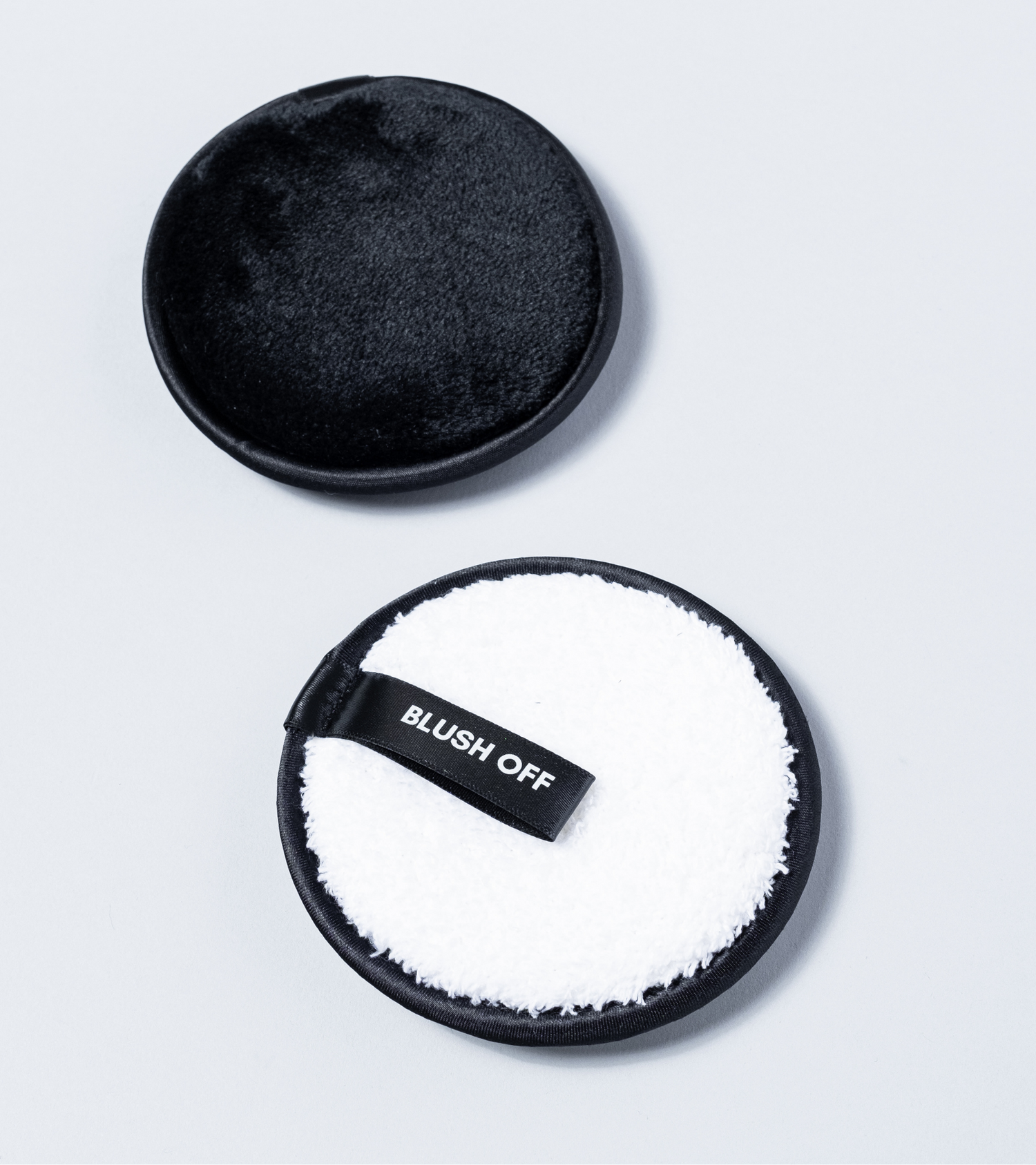 Black and white Blush Off reusable makeup remover pads with soft microfibre and finger strap